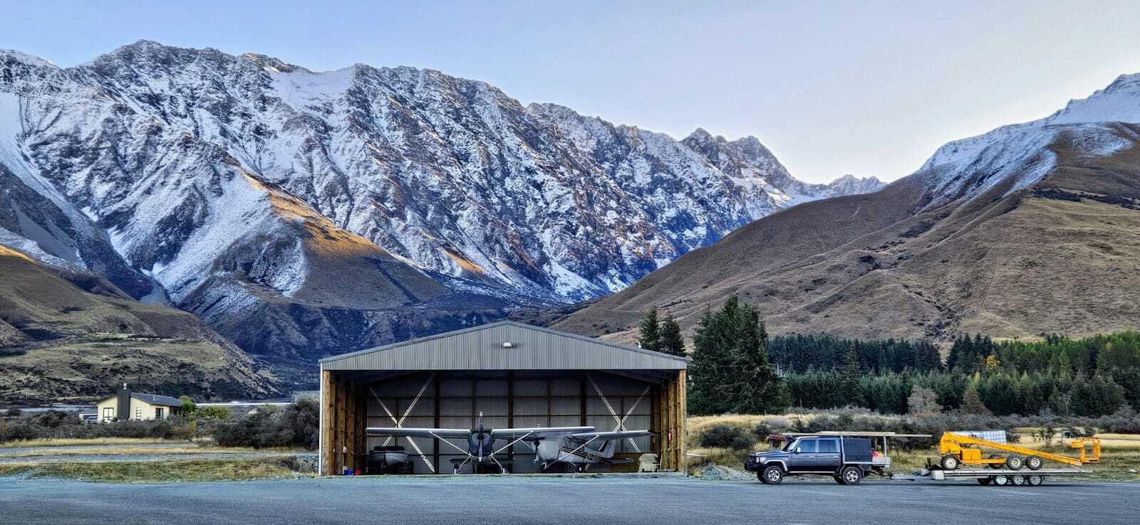 George Ivey picture with hangar and cruiser