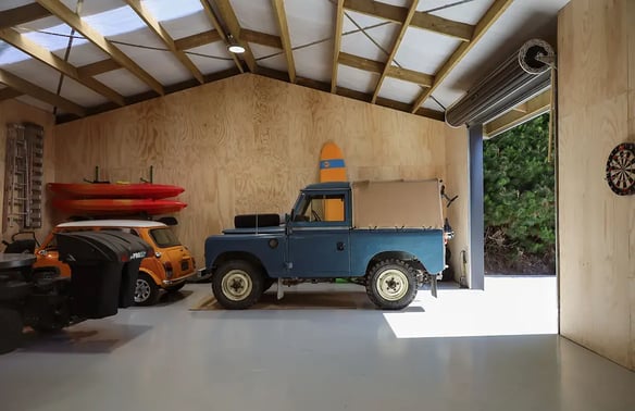 Classic cars inside an insulated, plywood lined Alpine shed